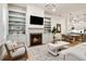 Open living area features a fireplace, built-in shelving, and a view into the kitchen area at 800 Old Plank Sq, Duluth, GA 30097