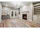 Living room with fireplace, built-in shelves, and French doors to backyard at 800 Old Plank Sq, Duluth, GA 30097