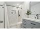Updated bathroom featuring a beautifully tiled shower, sleek black fixtures, and a modern grey vanity at 2026 Patterson Park Pl, Lawrenceville, GA 30044