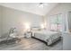 Bedroom featuring grey plank flooring, neutral paint, vaulted ceilings, and natural light from the exterior window at 2026 Patterson Park Pl, Lawrenceville, GA 30044