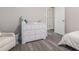 Bedroom featuring a large dresser, chair, and neutral decor at 2026 Patterson Park Pl, Lawrenceville, GA 30044