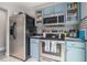 Well-lit kitchen with stainless steel appliances and blue cabinets at 2026 Patterson Park Pl, Lawrenceville, GA 30044