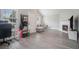 Bright living room featuring a fireplace, grey plank flooring, and modern neutral decor throughout the space at 2026 Patterson Park Pl, Lawrenceville, GA 30044