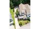 Aerial view of well maintained home with lush greenery, stone porch detail, and long driveway at 2360 Whispering Nw Dr, Kennesaw, GA 30144