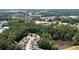 Aerial view of homes near a tree-lined community next to Downtown Kennesaw and a pond at 2360 Whispering Nw Dr, Kennesaw, GA 30144