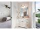 Bright bathroom features a vanity with a white marble countertop, mirror, and coastal themed decor at 2360 Whispering Nw Dr, Kennesaw, GA 30144