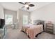 Bedroom with a large window and a sitting area in a neutral color scheme at 2360 Whispering Nw Dr, Kennesaw, GA 30144