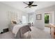 Cozy bedroom features natural light, neutral colors, a ceiling fan and coastal themed decorations at 2360 Whispering Nw Dr, Kennesaw, GA 30144