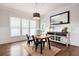 Bright dining room features a wooden table, stylish chairs, and a decorative accent wall with large windows at 2360 Whispering Nw Dr, Kennesaw, GA 30144