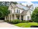 Charming two-story home with a welcoming front porch, manicured lawn and established landscaping at 2360 Whispering Nw Dr, Kennesaw, GA 30144