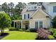 Charming two-story home with a welcoming front porch, manicured lawn and established landscaping at 2360 Whispering Nw Dr, Kennesaw, GA 30144