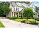 Charming two-story home with a well-manicured lawn, covered porch with stately columns, and a long driveway at 2360 Whispering Nw Dr, Kennesaw, GA 30144
