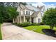 Charming two-story home with a welcoming front porch, manicured lawn and established landscaping at 2360 Whispering Nw Dr, Kennesaw, GA 30144