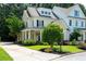 Charming two-story home featuring a manicured lawn, covered porch, and classic architectural details at 2360 Whispering Nw Dr, Kennesaw, GA 30144