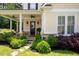 Inviting front porch with stone accents, ceiling fans, and manicured landscaping around the walkway at 2360 Whispering Nw Dr, Kennesaw, GA 30144