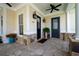 Close-up of front porch featuring a stone floor, ceiling fans, and elegant exterior lighting fixtures at 2360 Whispering Nw Dr, Kennesaw, GA 30144