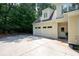 Spacious home featuring a two-car garage with ample parking space on a large concrete driveway at 2360 Whispering Nw Dr, Kennesaw, GA 30144