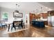 Spacious kitchen and dining area featuring wooden cabinets, a center island, and stainless steel appliances at 2360 Whispering Nw Dr, Kennesaw, GA 30144