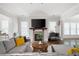 Cozy living room featuring a stone fireplace, large TV, and comfortable seating area at 2360 Whispering Nw Dr, Kennesaw, GA 30144