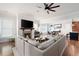 Open-concept living room with a fireplace, large sectional sofa, and view to the kitchen at 2360 Whispering Nw Dr, Kennesaw, GA 30144