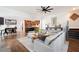 Spacious living room with hardwood floors, grey sofa, and seamless flow to the kitchen and dining area at 2360 Whispering Nw Dr, Kennesaw, GA 30144