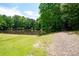 Scenic pond surrounded by lush greenery, trees, and open grassy area at 2360 Whispering Nw Dr, Kennesaw, GA 30144