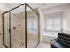 Bathroom with tile walk in shower and separate garden tub next to window at 2360 Whispering Nw Dr, Kennesaw, GA 30144