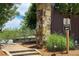 Community trail entrance featuring a stone pillar, a trail sign with an arrow, and lush greenery around the path at 2360 Whispering Nw Dr, Kennesaw, GA 30144