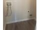 Dedicated laundry area with hookups for washer and dryer on wood look flooring at 2550 Presidents Walk, Tucker, GA 30084