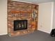 Cozy basement features a brick fireplace with wooden mantle and a built-in bookshelf at 4098 Nancy Creek Ne Way, Brookhaven, GA 30319