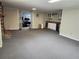 Finished basement featuring a brick fireplace, a kitchenette, and a large carpeted area at 4098 Nancy Creek Ne Way, Brookhaven, GA 30319