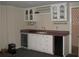 Finished basement bar area with white cabinets, wine rack, mini fridge, and sink at 4098 Nancy Creek Ne Way, Brookhaven, GA 30319