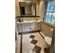 Bathroom features a tiled floor, vanity, and window, with the toilet at 4098 Nancy Creek Ne Way, Brookhaven, GA 30319