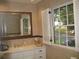 Bright bathroom features marble walls, a white vanity, and a large window with natural light at 4098 Nancy Creek Ne Way, Brookhaven, GA 30319