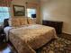 Bright bedroom featuring a patterned bed spread, a dresser, and natural light from two windows at 4098 Nancy Creek Ne Way, Brookhaven, GA 30319