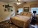 Cozy bedroom with a ceiling fan, patterned bedding, and natural light from two windows at 4098 Nancy Creek Ne Way, Brookhaven, GA 30319