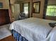 Bright primary bedroom with four-poster bed, floral accents, and sunlit windows at 4098 Nancy Creek Ne Way, Brookhaven, GA 30319