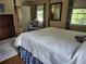 Bright primary bedroom with four-poster bed, floral accents, and sunlit windows at 4098 Nancy Creek Ne Way, Brookhaven, GA 30319