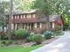 Charming two-story home with brick and wood accents, lush landscaping, and an inviting driveway at 4098 Nancy Creek Ne Way, Brookhaven, GA 30319
