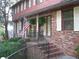 Welcoming front porch with brick stairs, black wrought iron railing and American flag at 4098 Nancy Creek Ne Way, Brookhaven, GA 30319