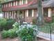 Inviting front yard with colorful hydrangeas, a charming scarecrow decoration, and a pathway to the entrance at 4098 Nancy Creek Ne Way, Brookhaven, GA 30319