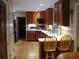 Charming kitchen with wooden cabinetry, modern appliances, and a breakfast bar area with barstool seating at 4098 Nancy Creek Ne Way, Brookhaven, GA 30319