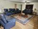 Spacious living room with hardwood floors, leather seating, and a large area rug at 4098 Nancy Creek Ne Way, Brookhaven, GA 30319