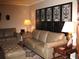 Living room with beige leather sofas, decorative screen, ornate lamps, and an area rug at 4098 Nancy Creek Ne Way, Brookhaven, GA 30319