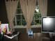 Desk features a computer monitor and a view of the yard with three windows at 4098 Nancy Creek Ne Way, Brookhaven, GA 30319