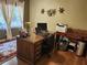 Home office features a desk, chair, shelving, and lots of natural light at 4098 Nancy Creek Ne Way, Brookhaven, GA 30319
