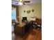 Home office features a desk, chair, shelving, and lots of natural light at 4098 Nancy Creek Ne Way, Brookhaven, GA 30319