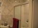 Shower includes glass doors, marble walls, and a white shower base at 4098 Nancy Creek Ne Way, Brookhaven, GA 30319