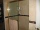 The shower features glass doors, marble walls, and two shower products at 4098 Nancy Creek Ne Way, Brookhaven, GA 30319