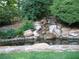 Backyard with rock water feature and pond at 4098 Nancy Creek Ne Way, Brookhaven, GA 30319